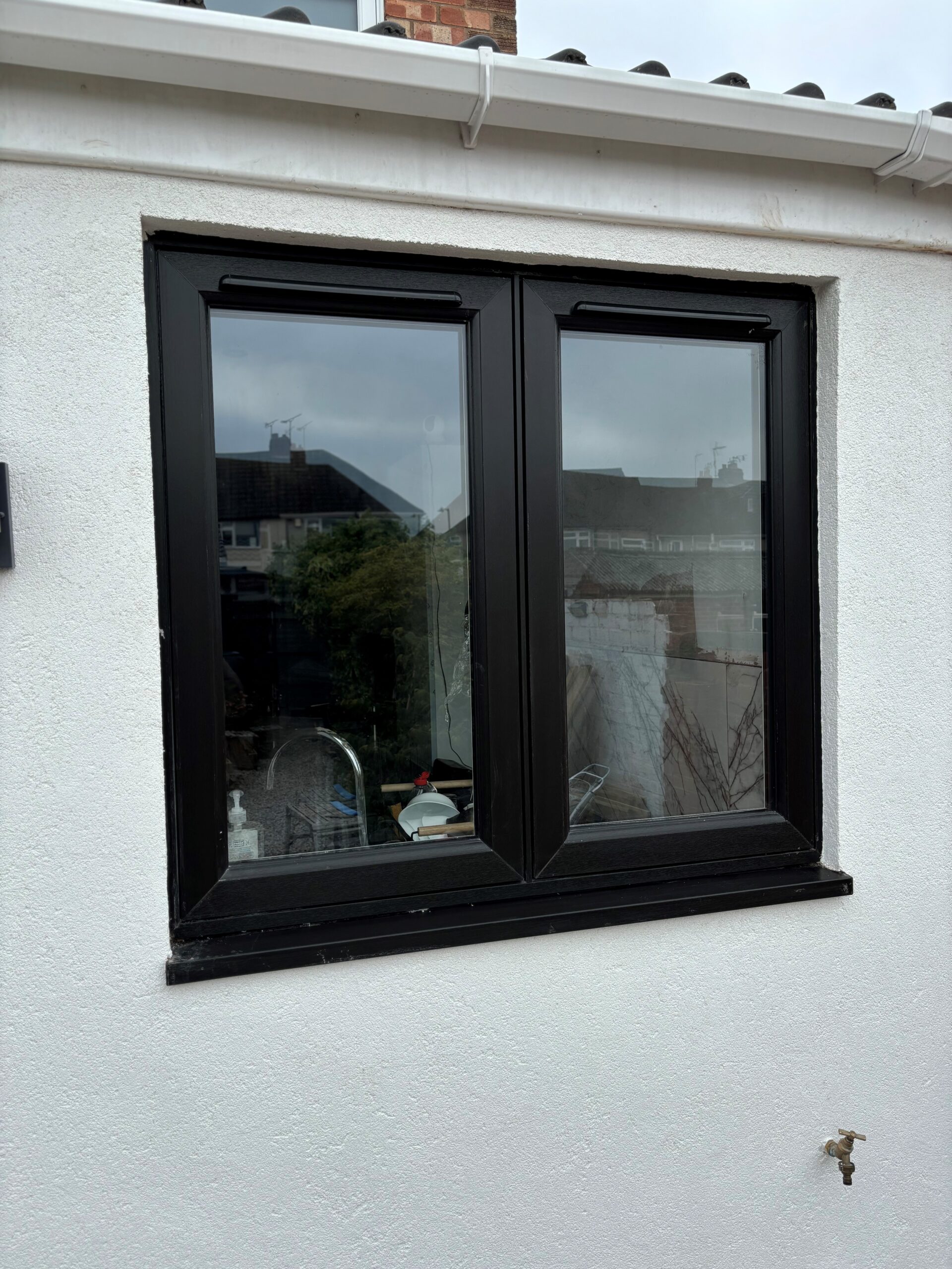 Black on white uPVC window installed by Eco Windows