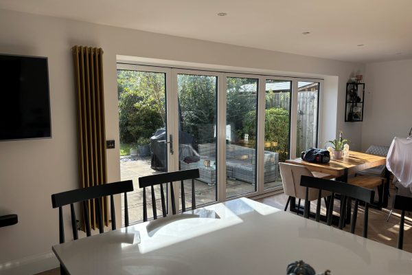 White Aluminium Bi Fold door installed by Eco Windows